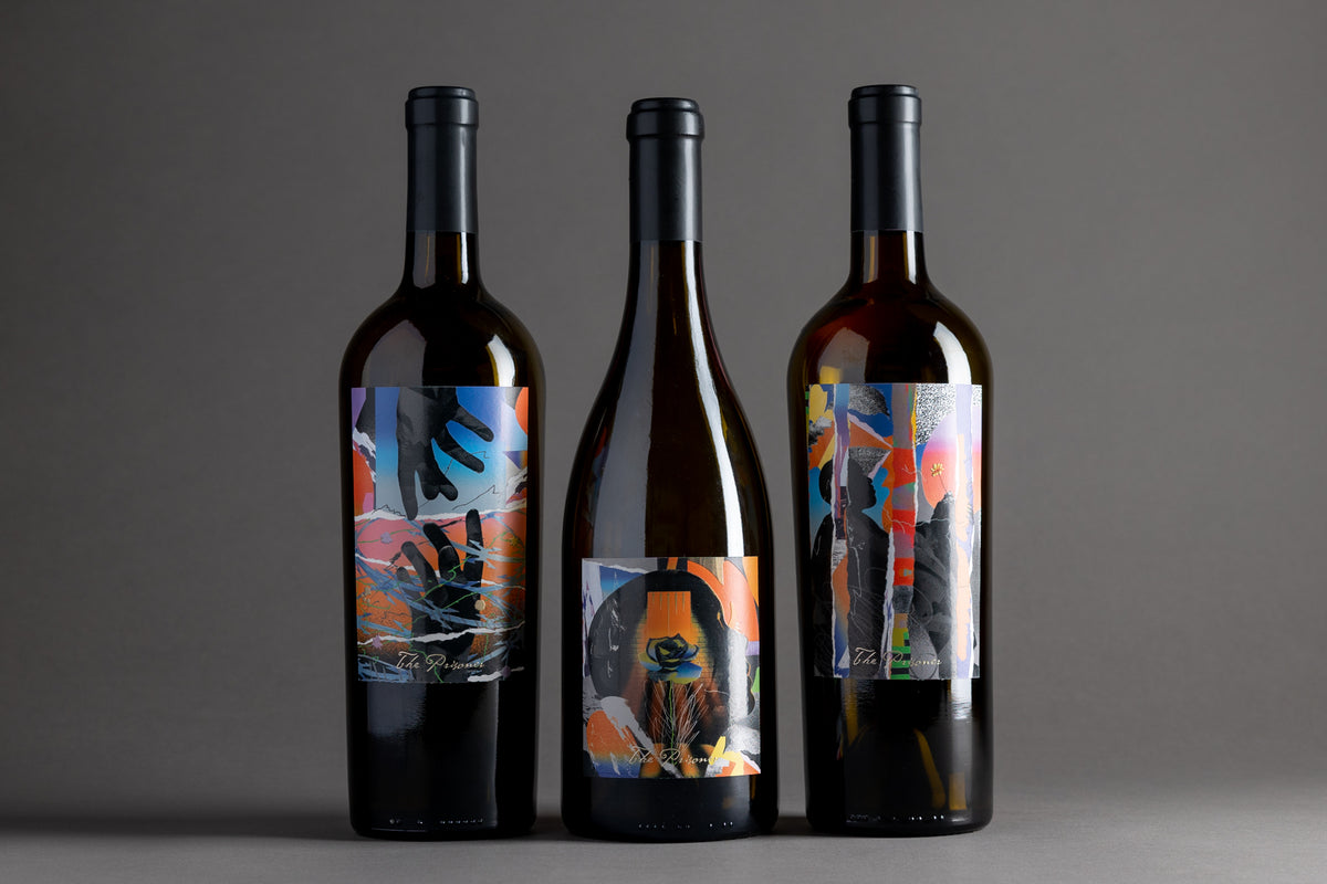 Three bottles of The Corrections Wines in a row on a gray background