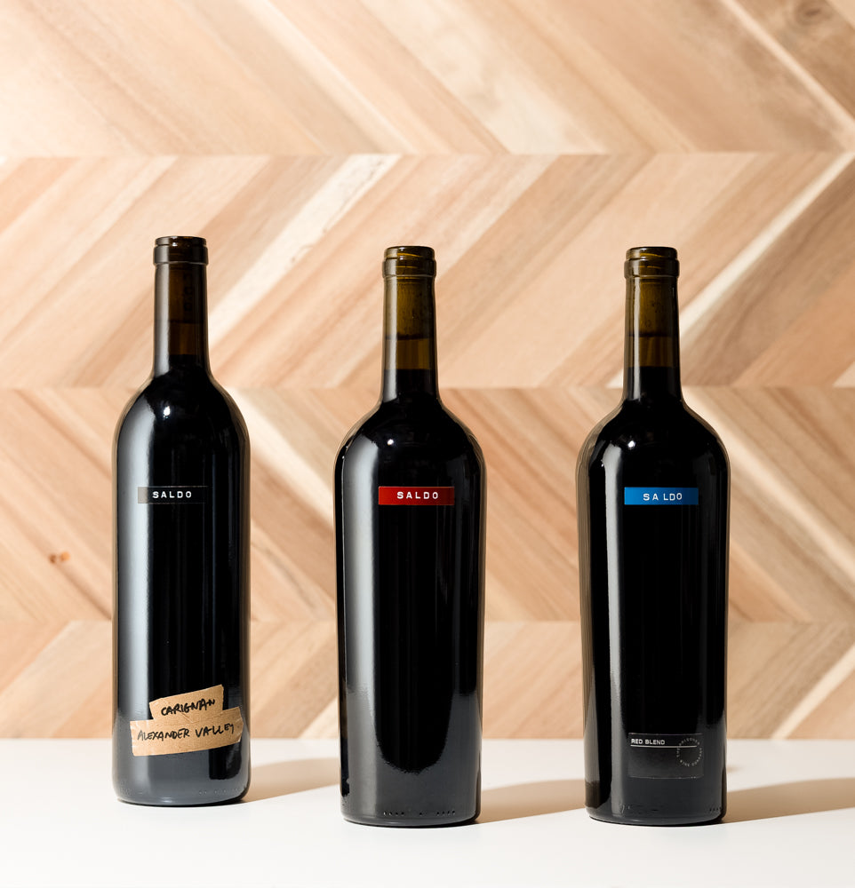 SALDO Red Trio bottles of wine with wooden background