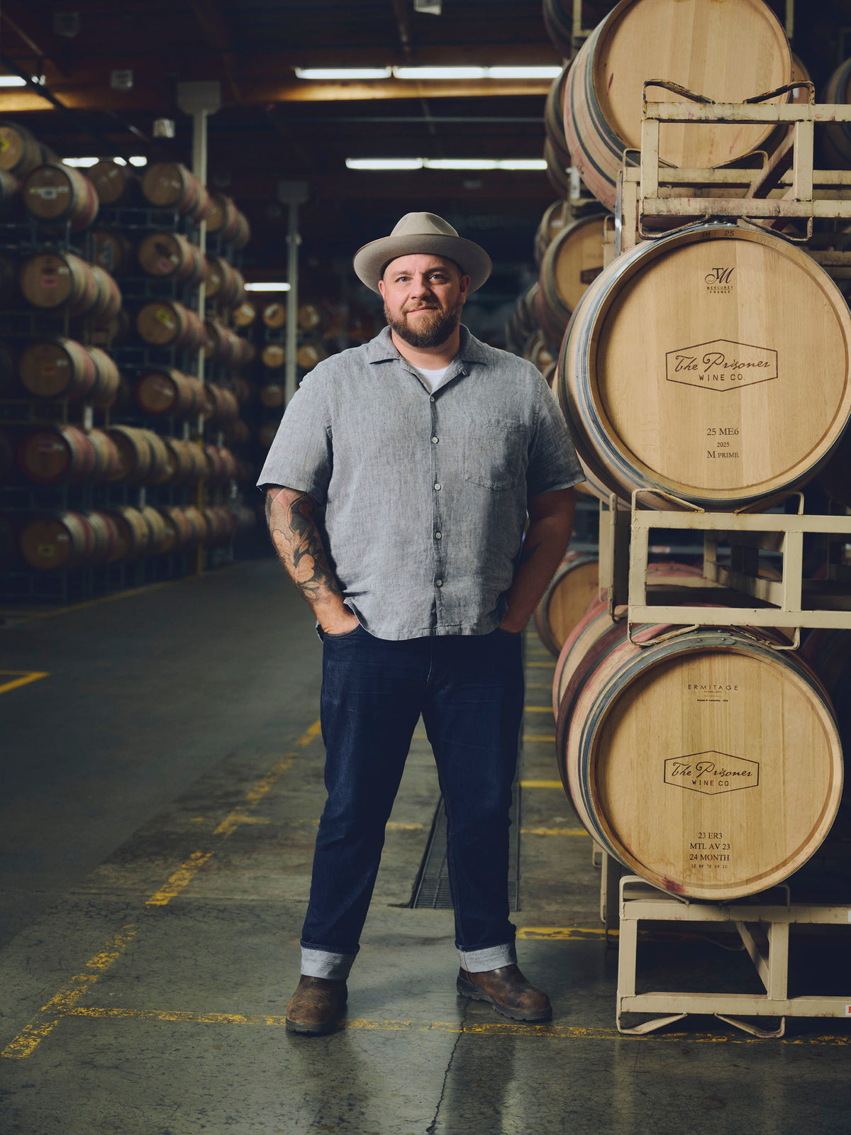 image of our winemaker Todd Ricard standing by wine barrels 