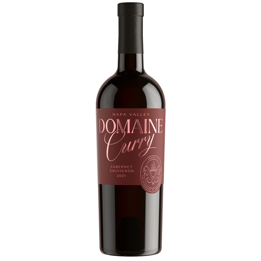 A bottle of Domaine Curry Napa Valley Cabernet Sauvignon 2021, featuring a dark glass bottle with a black cap and a dusty rose label with gold lettering.