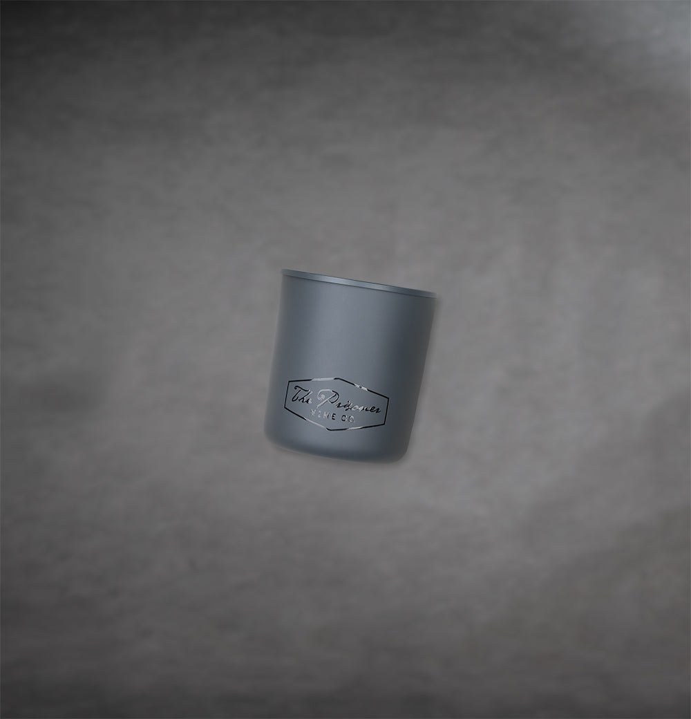 The Prisoner scented candle on a gray background