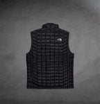 Back of Black North Face Vest by The Prisoner with logo on front right 