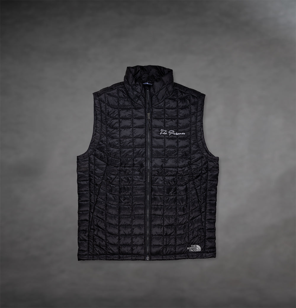 Front of Black North Face Vest by The Prisoner with logo on front right 