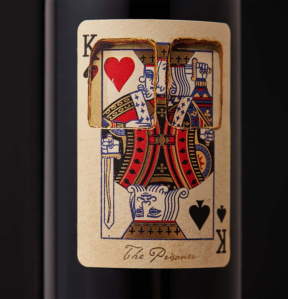A bottle of The Prisoner x Corrections wine with a playing card label