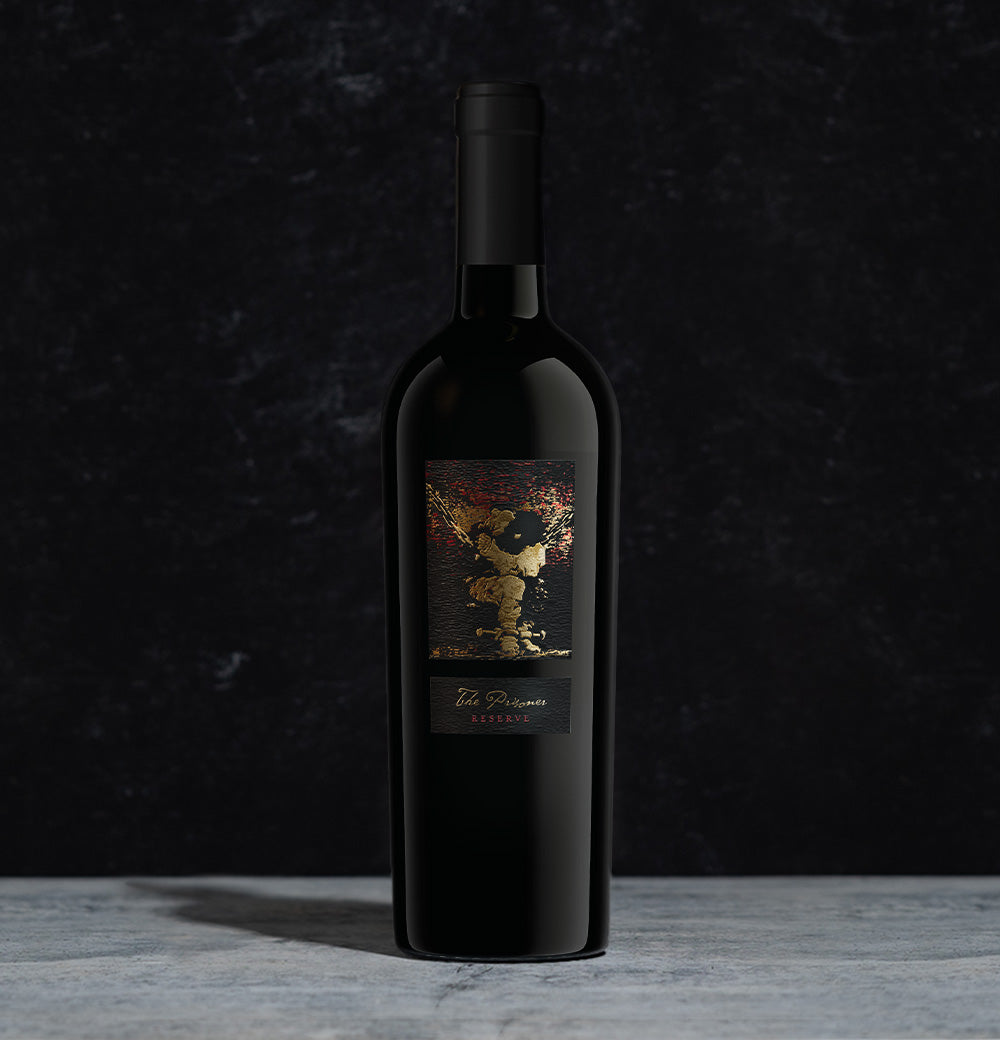 A bottle of The Prisoner Reserve Red Blend on a dark background