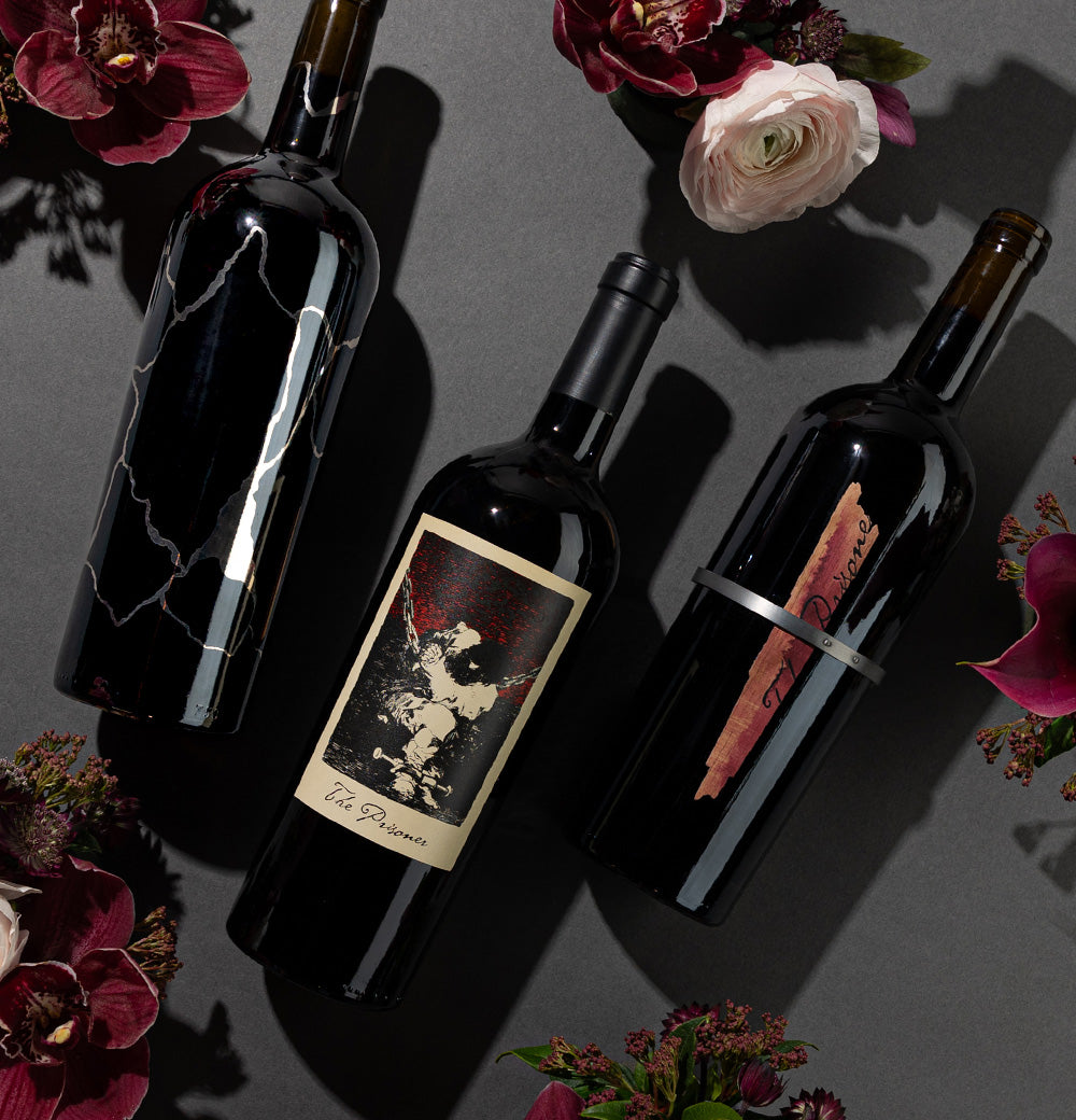 The Prisoner Red Blend, Solder and Sliver red wines next to flowers