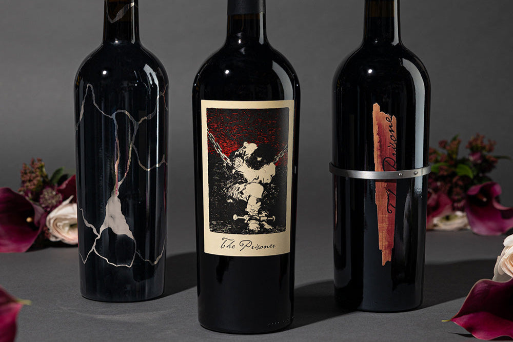 The Prisoner Red Blend, Solder and Sliver red wines next to flowers