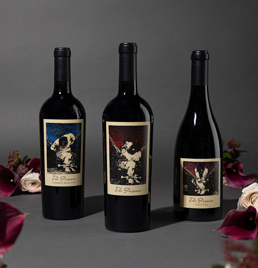 The Prisoner Red Blend, Pinot Noir and Cabernet Sauvignon next to flowers