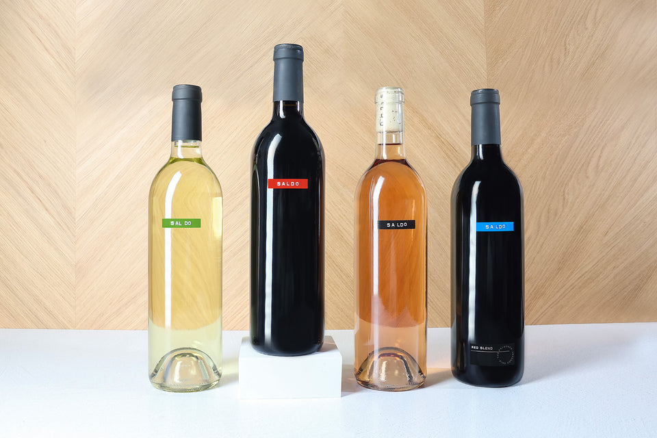 SALDO Wine Line Up on a white table and a wooden background