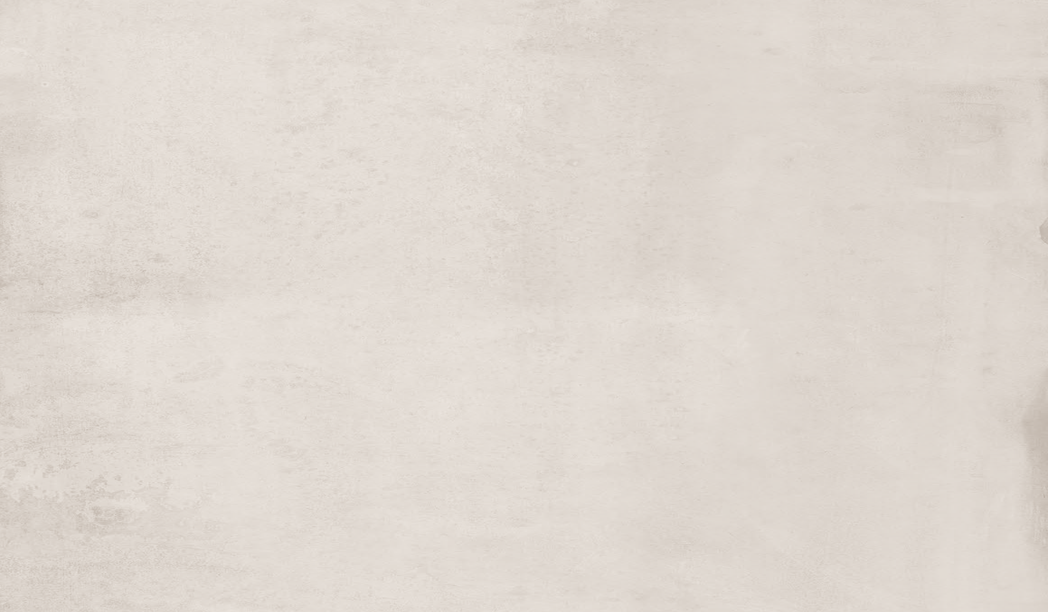 A full-frame close-up of a light warm gray or off-white textured surface, resembling concrete, plaster, or stone.
