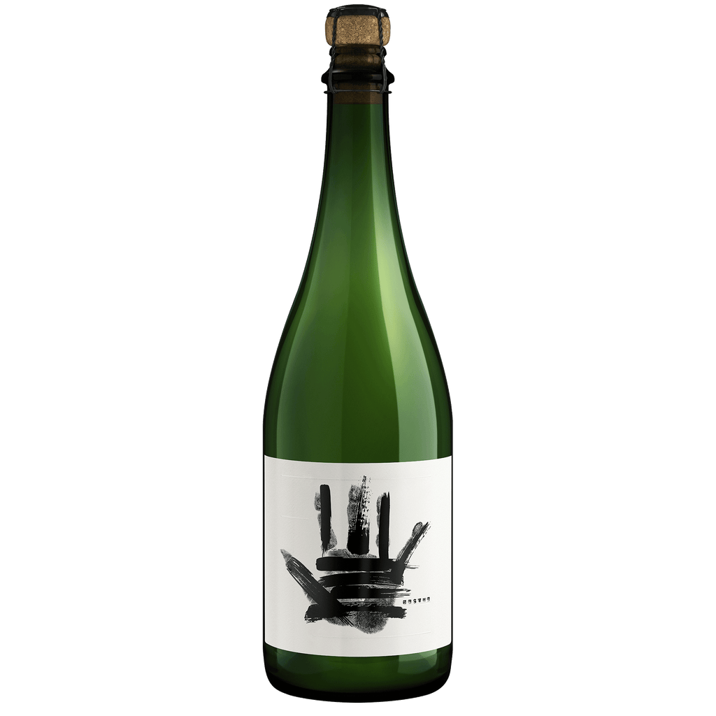 A bottle of The Prisoner Erased Sparkling with a cork stopper and a white label featuring a black handprint design, isolated on a white background.