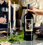 The Prisoner Red Blend Magnum Etched with "Happy Holidays" on a table