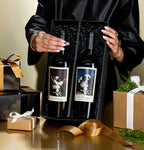 Woman holding The Prisoner Red Blend and Cabernet Sauvignon in a black gift box