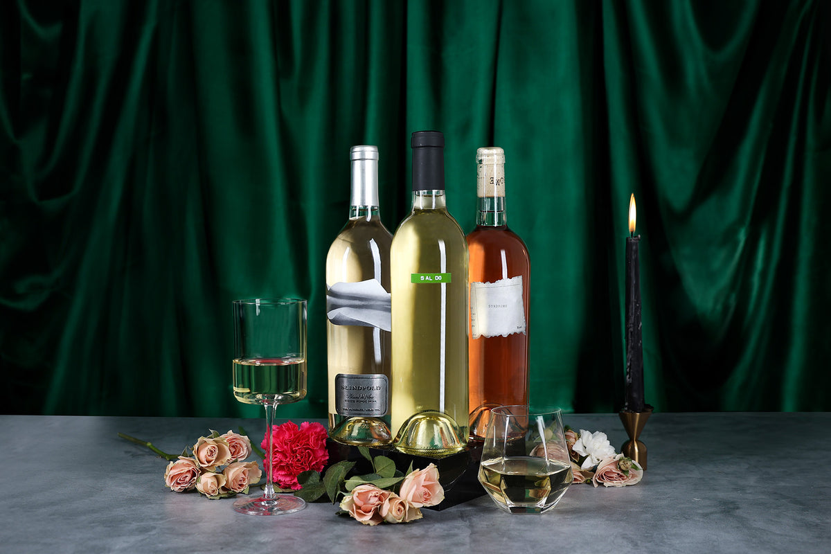 Bottle of SALDO chenin blanc, Syndrome Rose and Blindfold Blanc de Noir next to roses