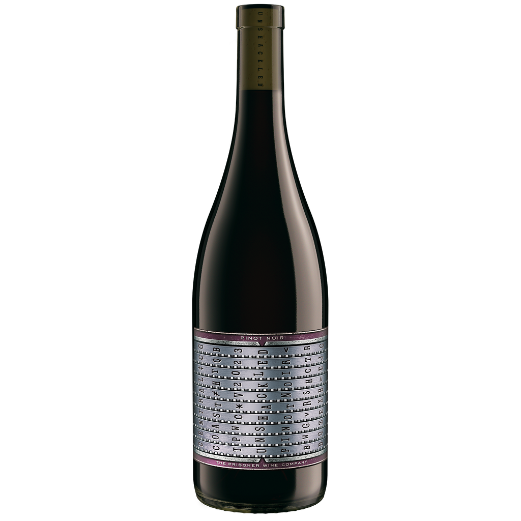 A bottle of Unshackled Pinot Noir wine against a solid white background. The bottle is dark glass with a silver and purple label featuring black text, and a gold foil-wrapped neck.