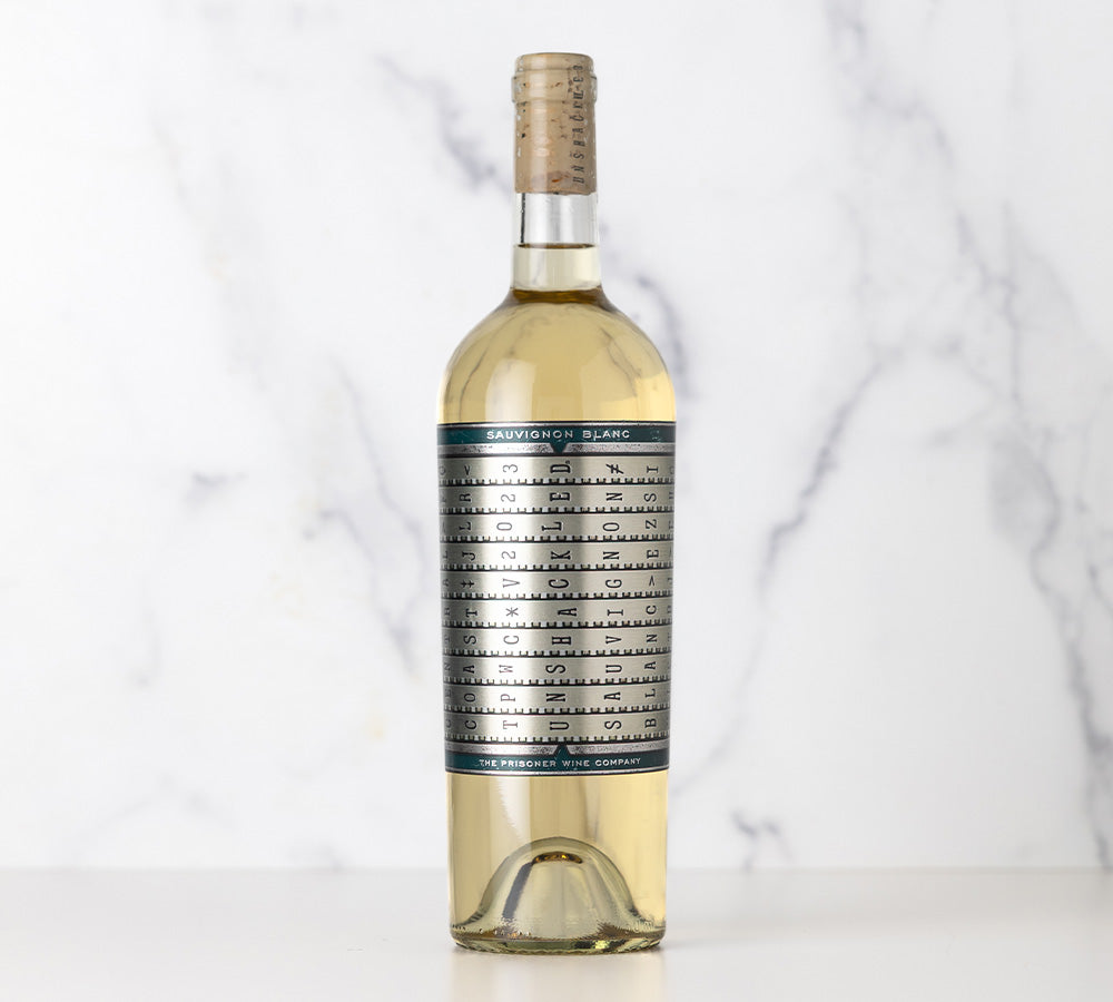Bottle of Unshackled Sauvignon Blanc wine with a label on a white background