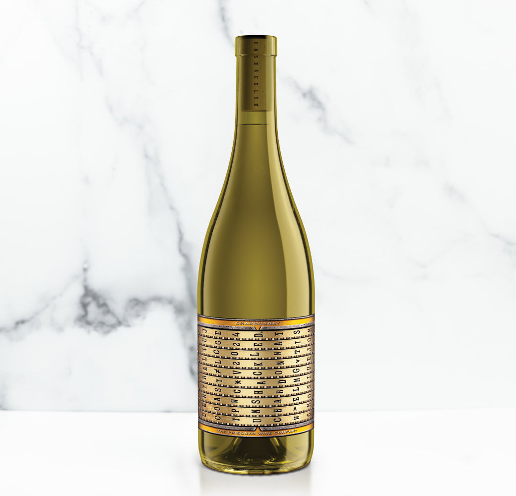 Unshackled wine bottle with a gold label on a marble background