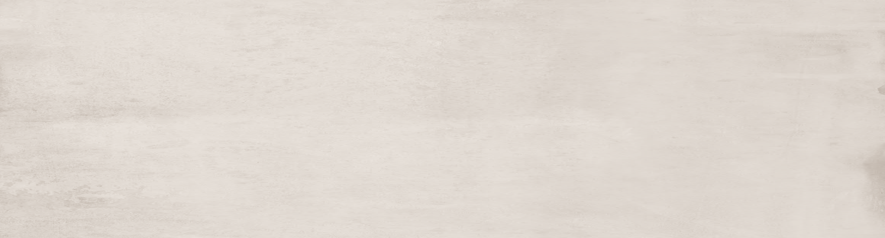 A close-up of a light beige textured surface with subtle horizontal grain or plaster-like variation.