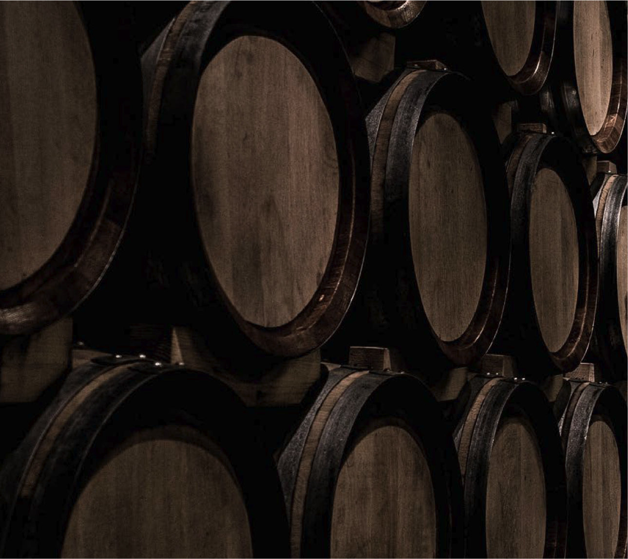 Stack of wooden barrels in a dark setting