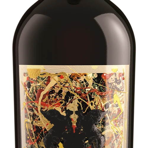 Close-up of a dark wine bottle with an abstract multicolor label featuring black, gold, red, and beige paint-like splatters on a white background.