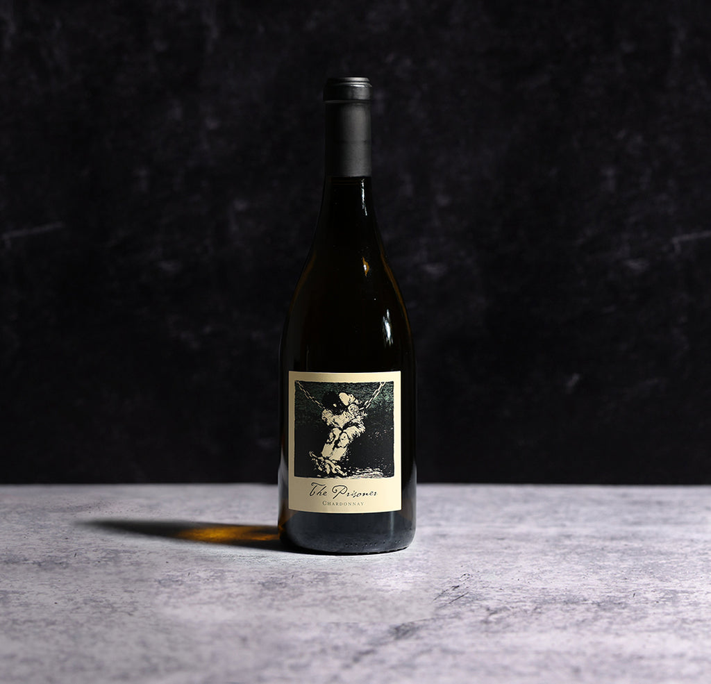 A Bottle Of  2022 The Prisoner Chardonnay Carneros Wine On A Gray Background